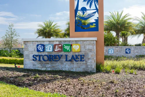 Storey Lake entrance sign surrounded by palms and landscaping